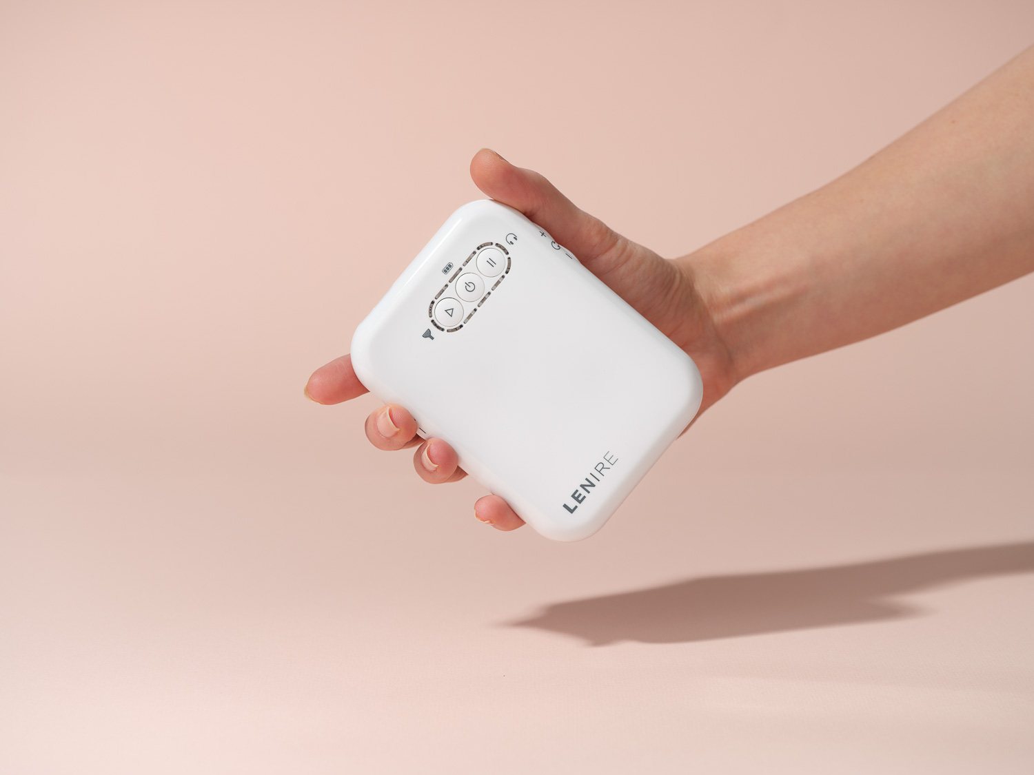 A hand holding the Lenire handheld controller